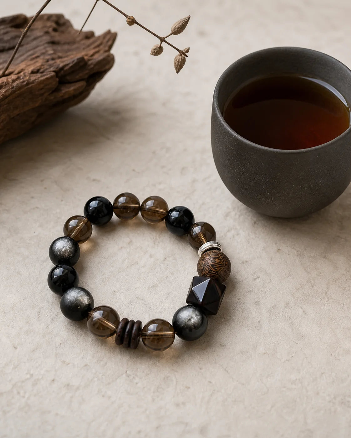 Aged Liu Bao bracelet beside a tea cup
