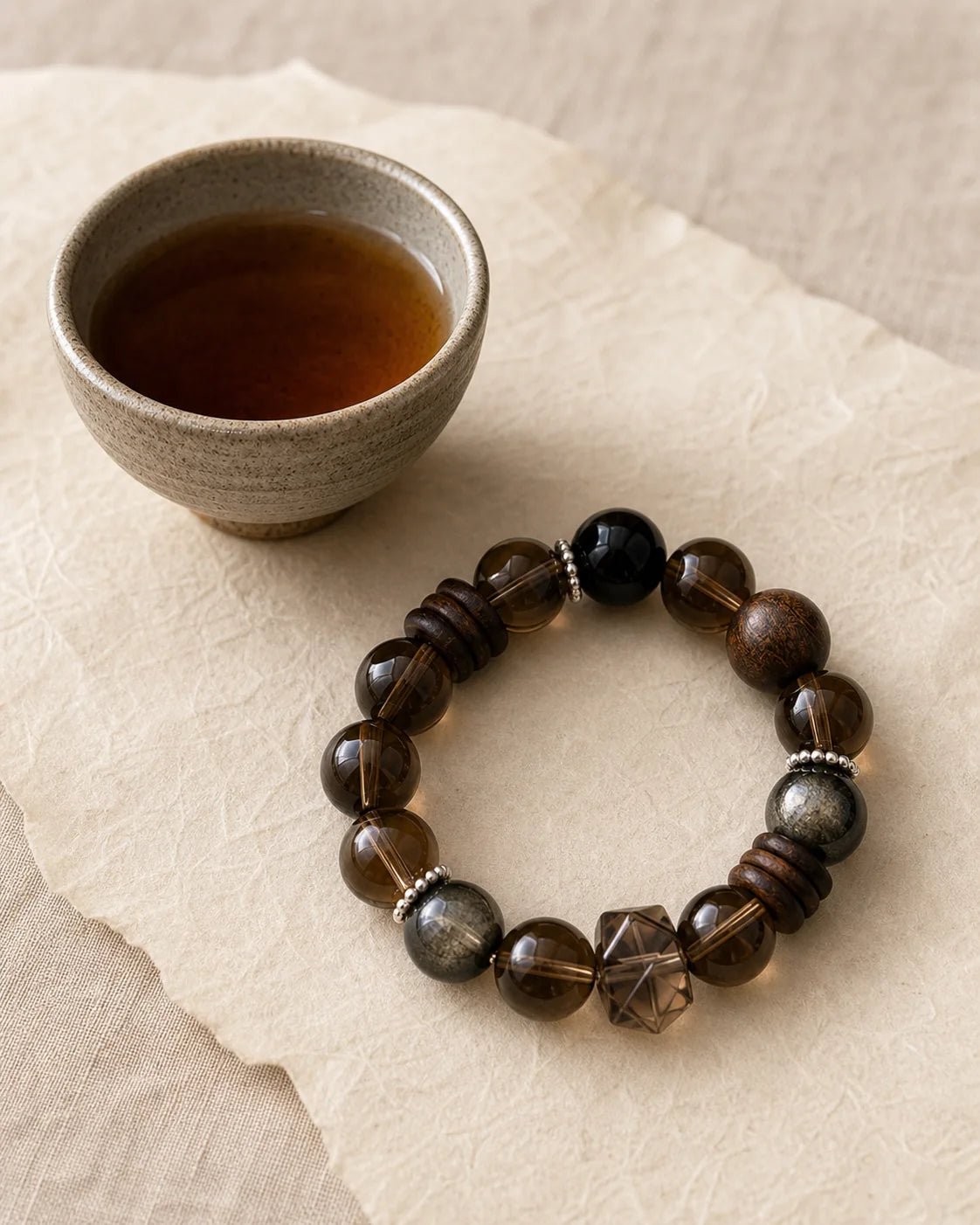 Aged Oolong bracelet beside a tea cup