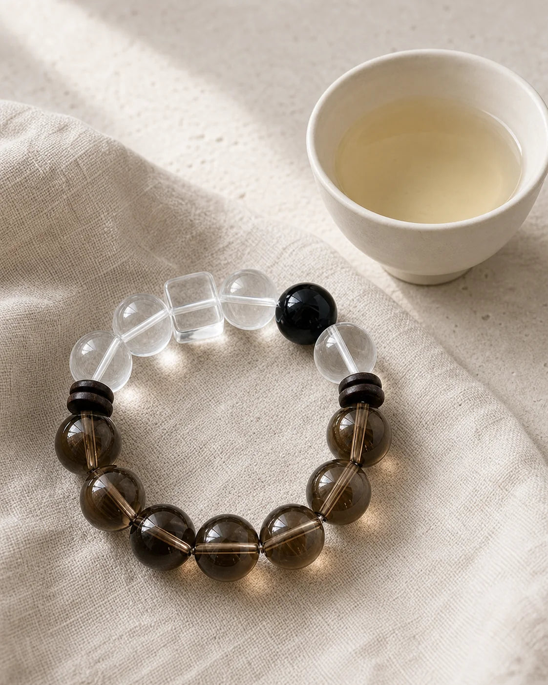 White Peony bracelet beside a tea cup