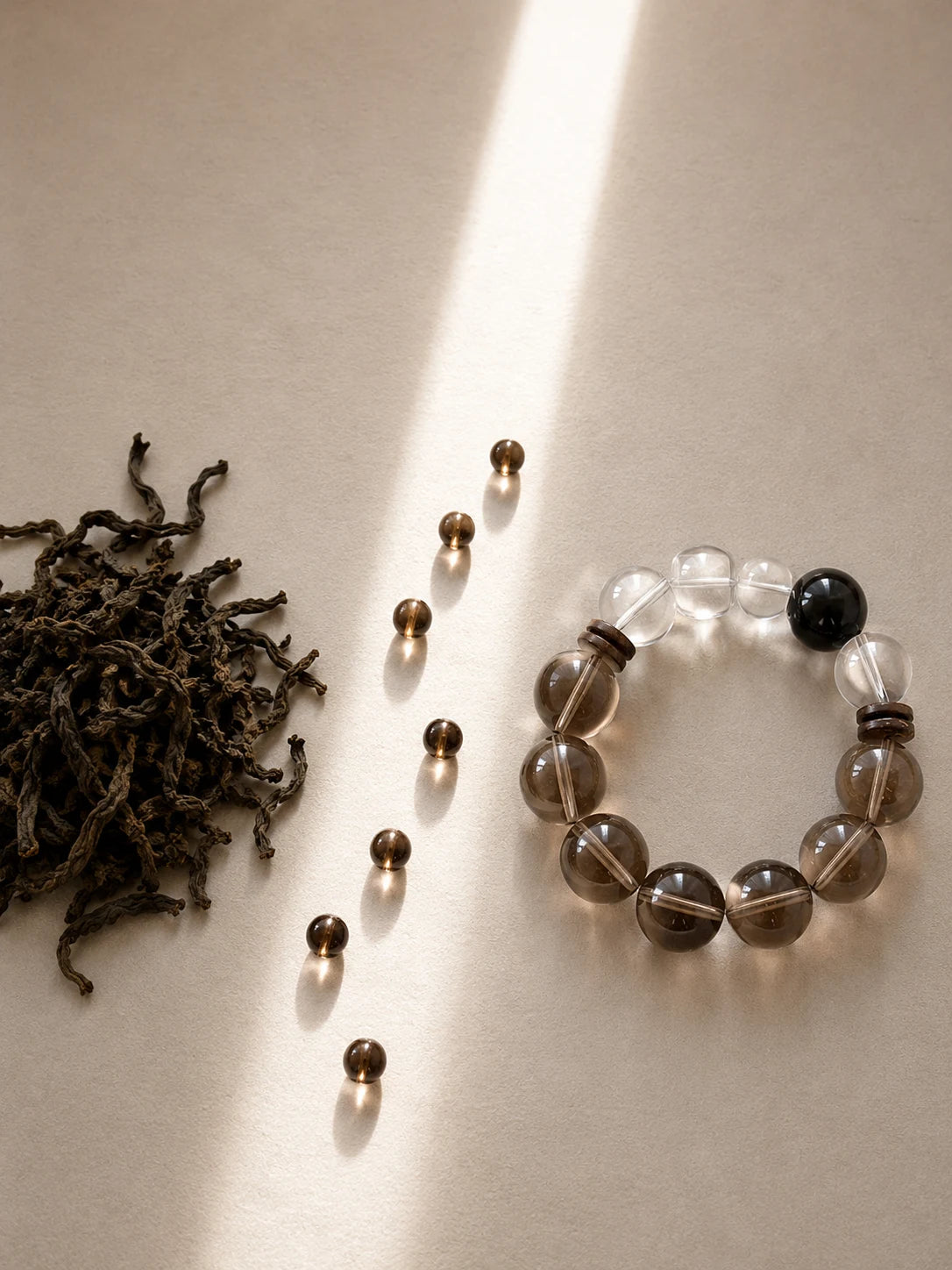 Smoky and clear crystal bracelet in a line of morning light